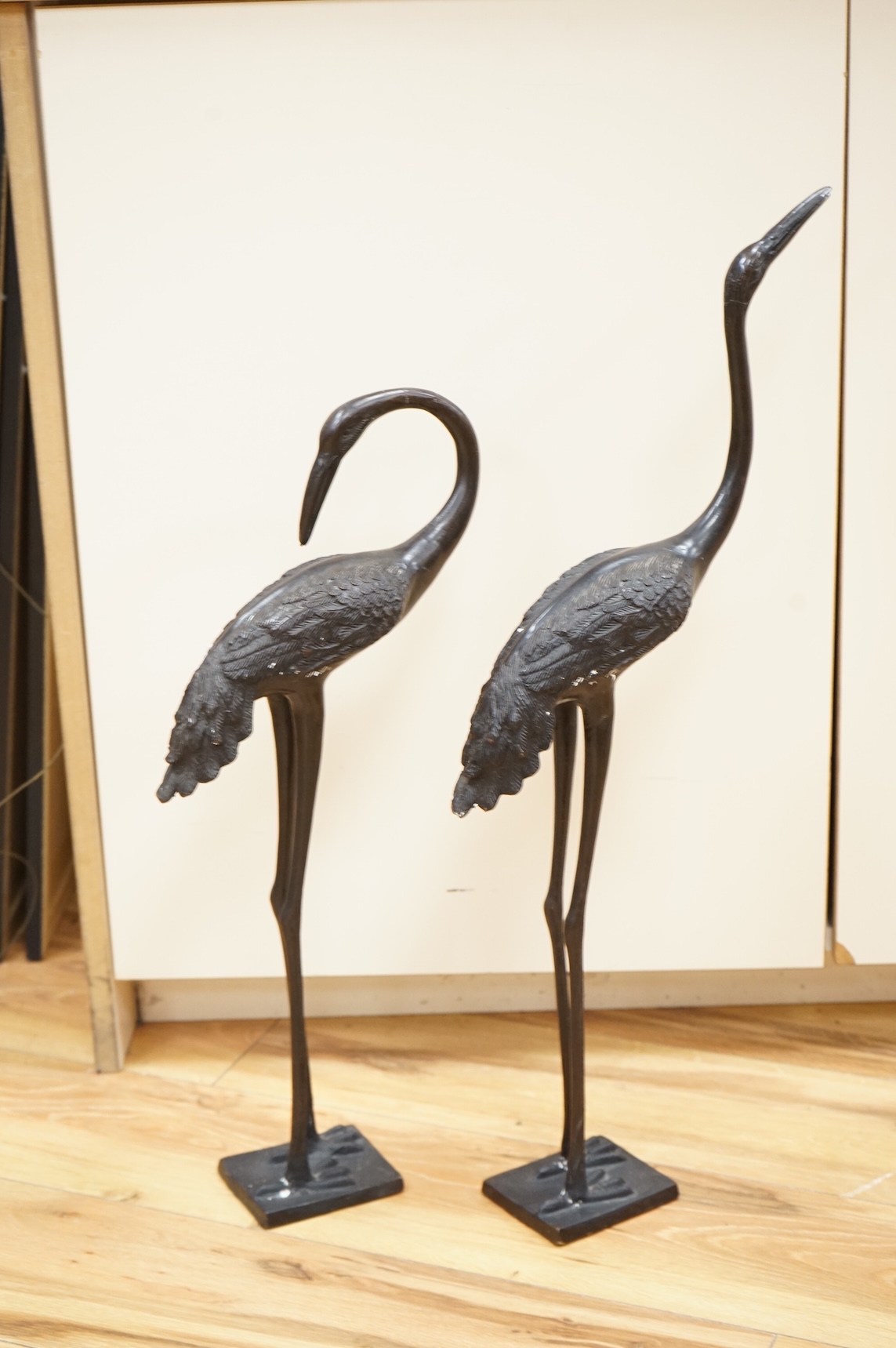 A pair of patinated bronze cranes, 62cm